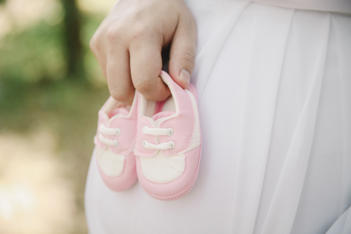 A Person Holding Pink Baby Shoes