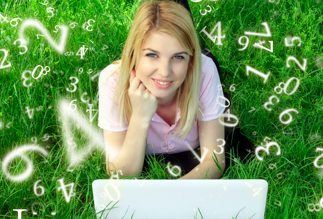 numerology, a young girl, blonde, lies in the grass with a laptop, surrounded by numbers, online services