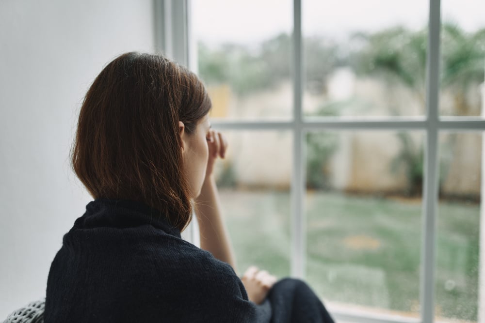 Sad Woman Sitting at Home