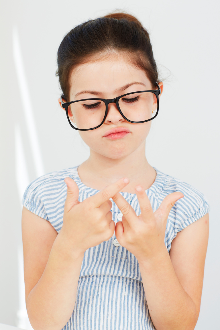 Young girl in glasses counting fingers